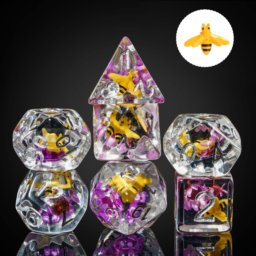 Cusdie dice close-up; bee in purple flower interior seen through transparent resin