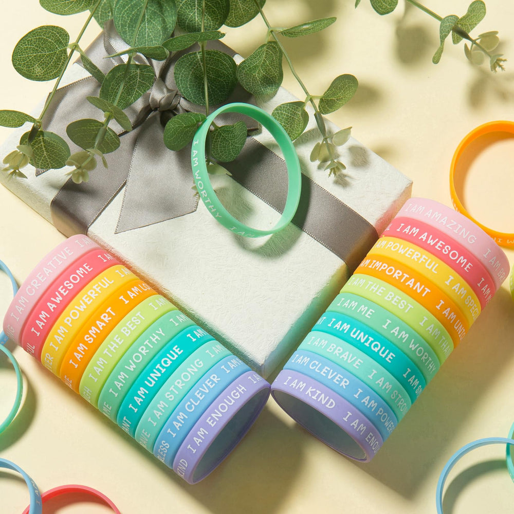 CYCLUSIVE wristbands with I AM STRONG quote for resilience.