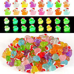 Diinokiy 160pcs Christmas resin ducks glow in the dark for fairy garden displays.