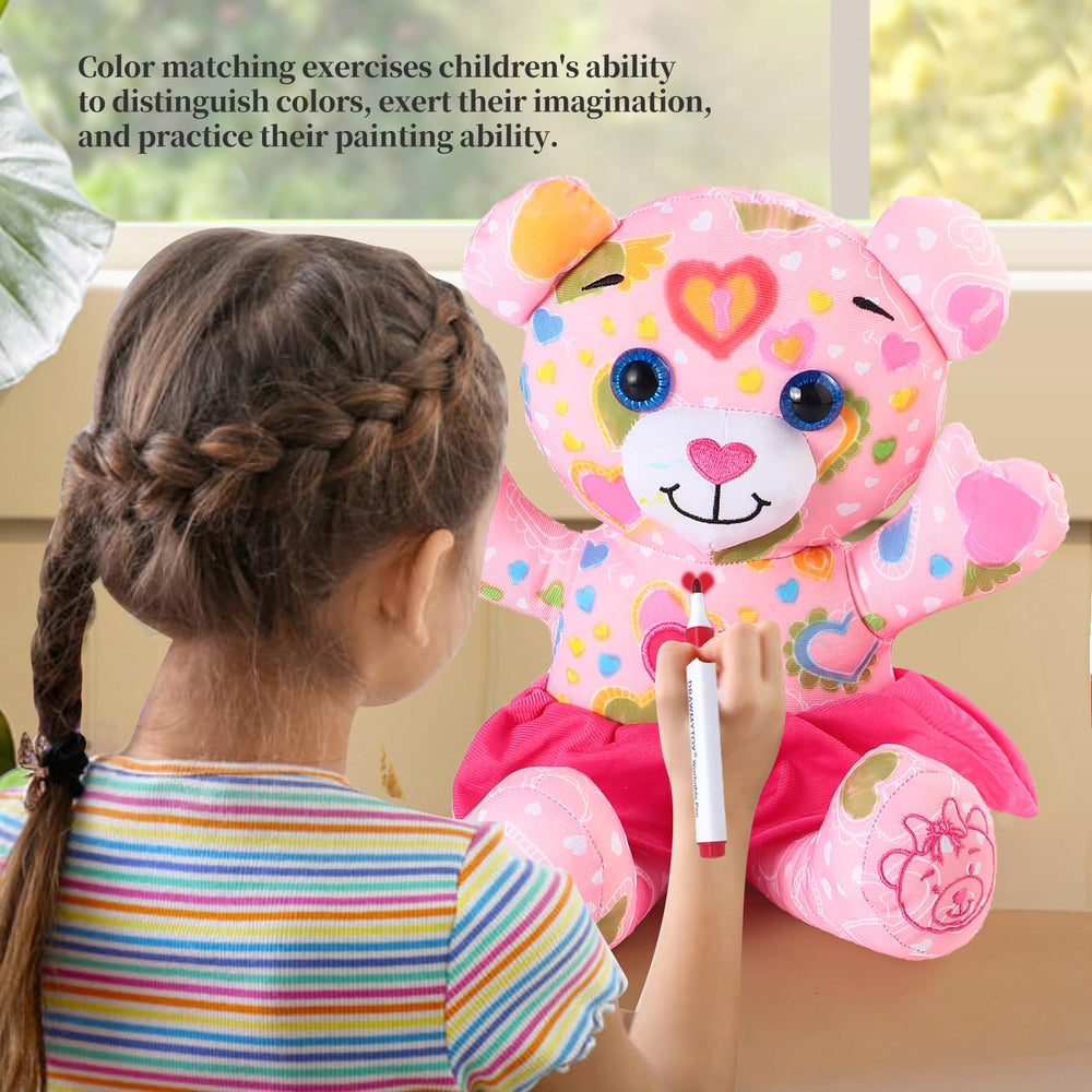 Child using DRAWMYTOY markers to doodle on plush toy