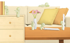 Dreams Smiski curious creature displayed on a shelf.