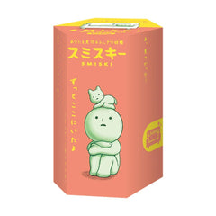 Dreams Smiski glow-in-the-dark figure glowing softly on a nightstand.