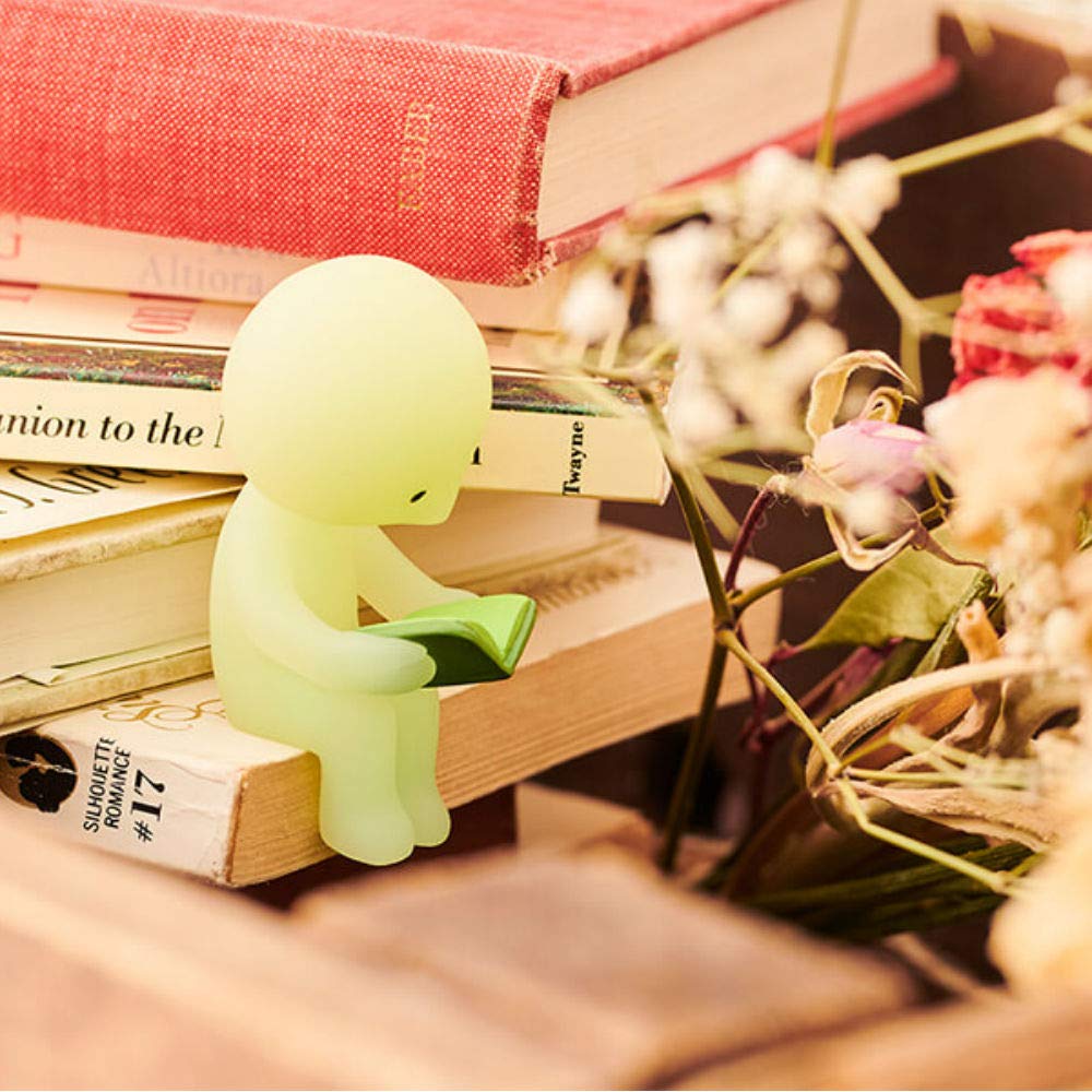 Dreams Smiski glow-in-the-dark living-taking-a-nap figure offers a soft glow at dusk