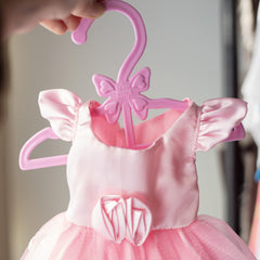 Dress Along Dolly hangers displaying dresses, skirts, and accessories for easy access