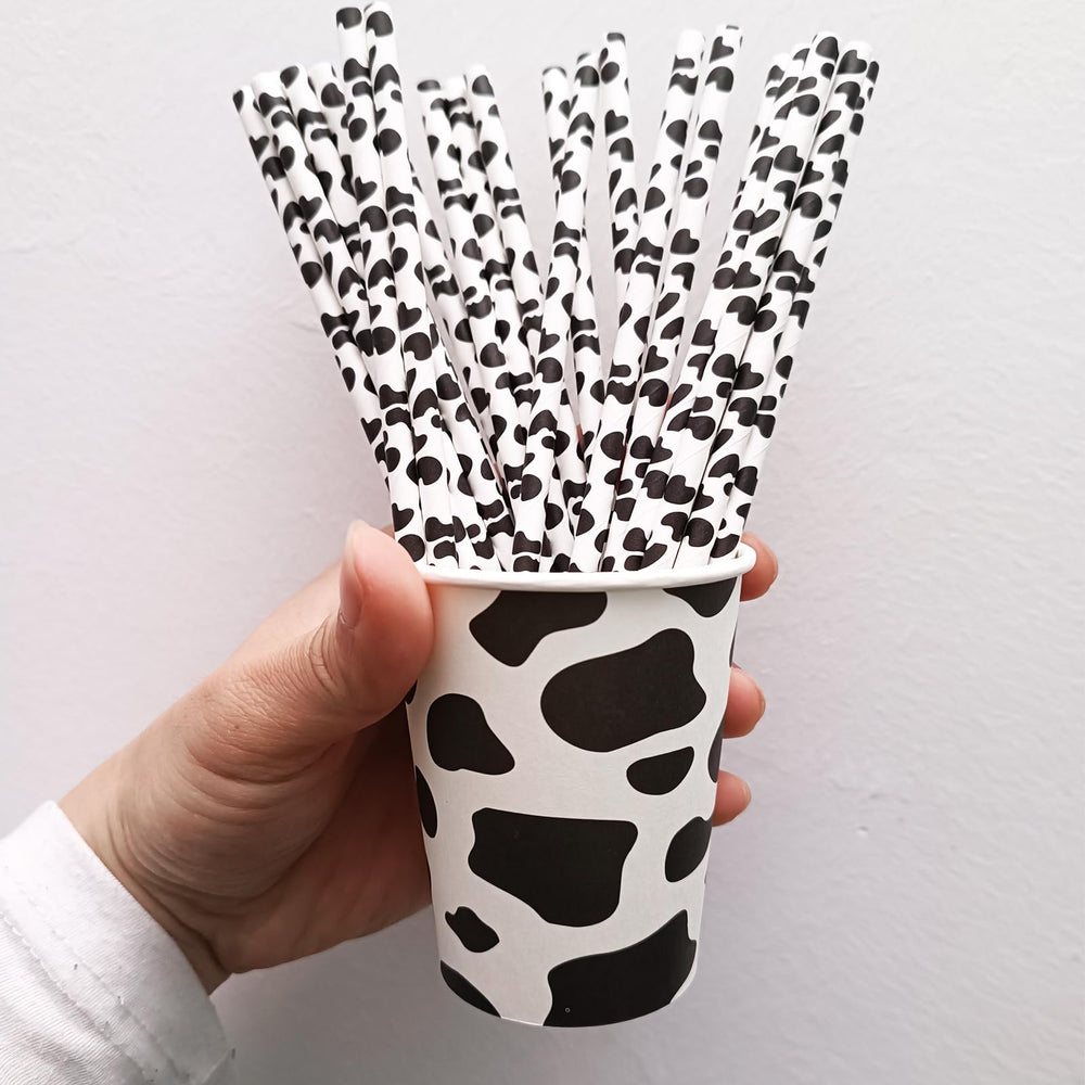 Farm-themed party decorations with cow print elements by EaciTown.