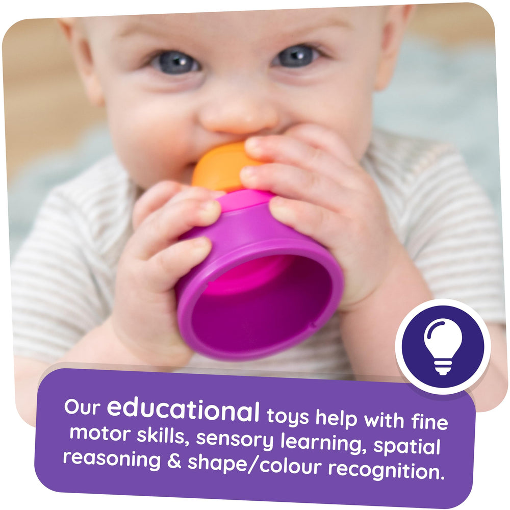 Fat Brain Toys Dimpl Stack child hands exploring push-pops to develop finger coordination.