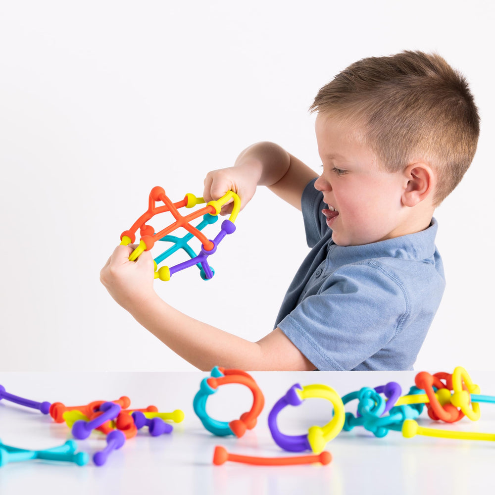 Fat Brain Toys Plip Kit children building together fosters cooperative play.
