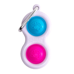 Fat Brain Toys Simpl Dimpl blue pink hand-press demonstrates tactile relief for focus.