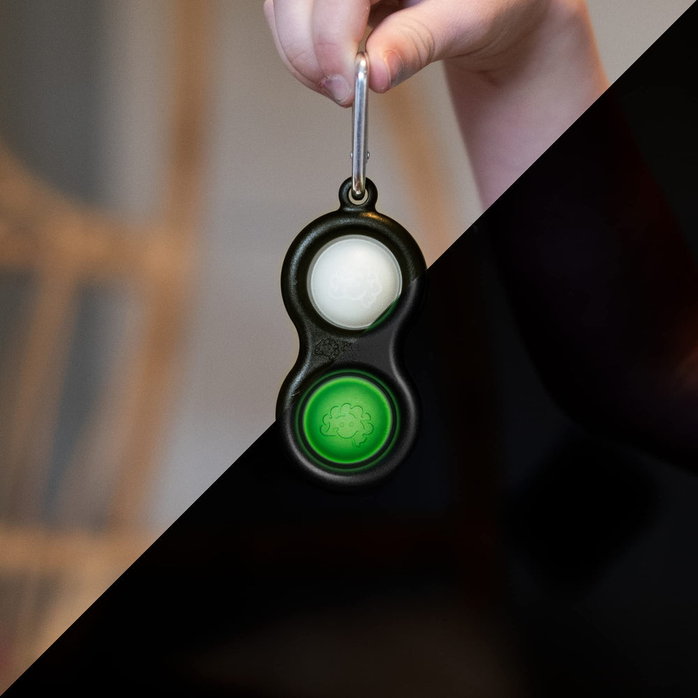 Fat Brain Toys Simpl Dimpl glow-dark close-up buttons demonstrating tactile stimulation for fine motor practice.