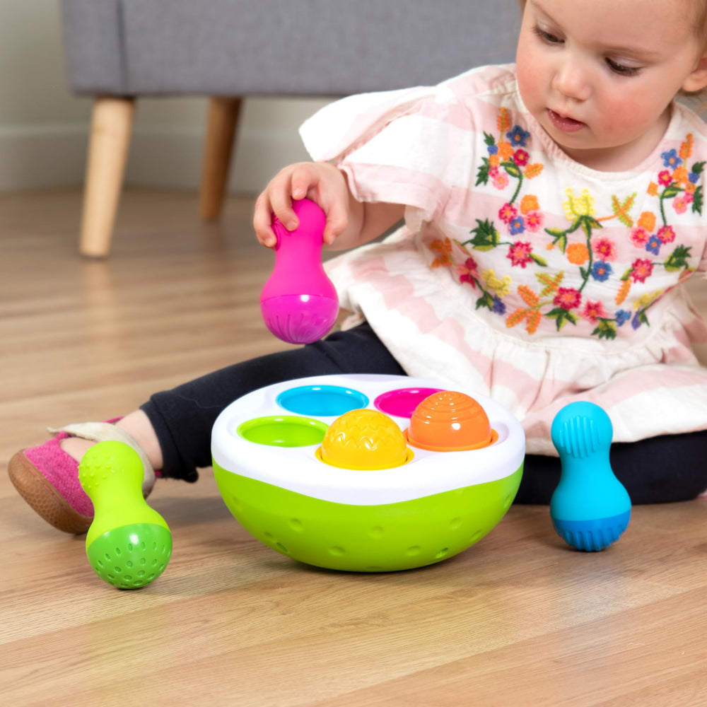 Fat Brain SpinnyPins chimes provide gentle auditory feedback during play.