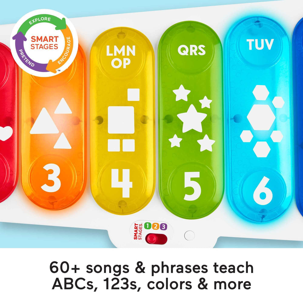 Toddler seated with the xylophone exploring sounds and colors during play.