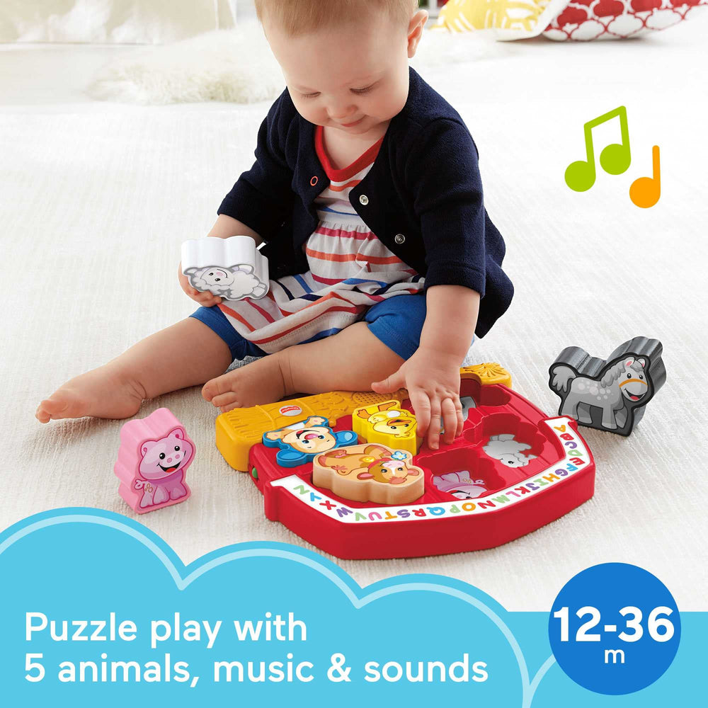 Close-up of farm animal puzzle pieces aiding grasping and fine motor development with Fisher-Price toy.