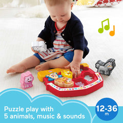 Close-up of farm animal puzzle pieces aiding grasping and fine motor development with Fisher-Price toy.