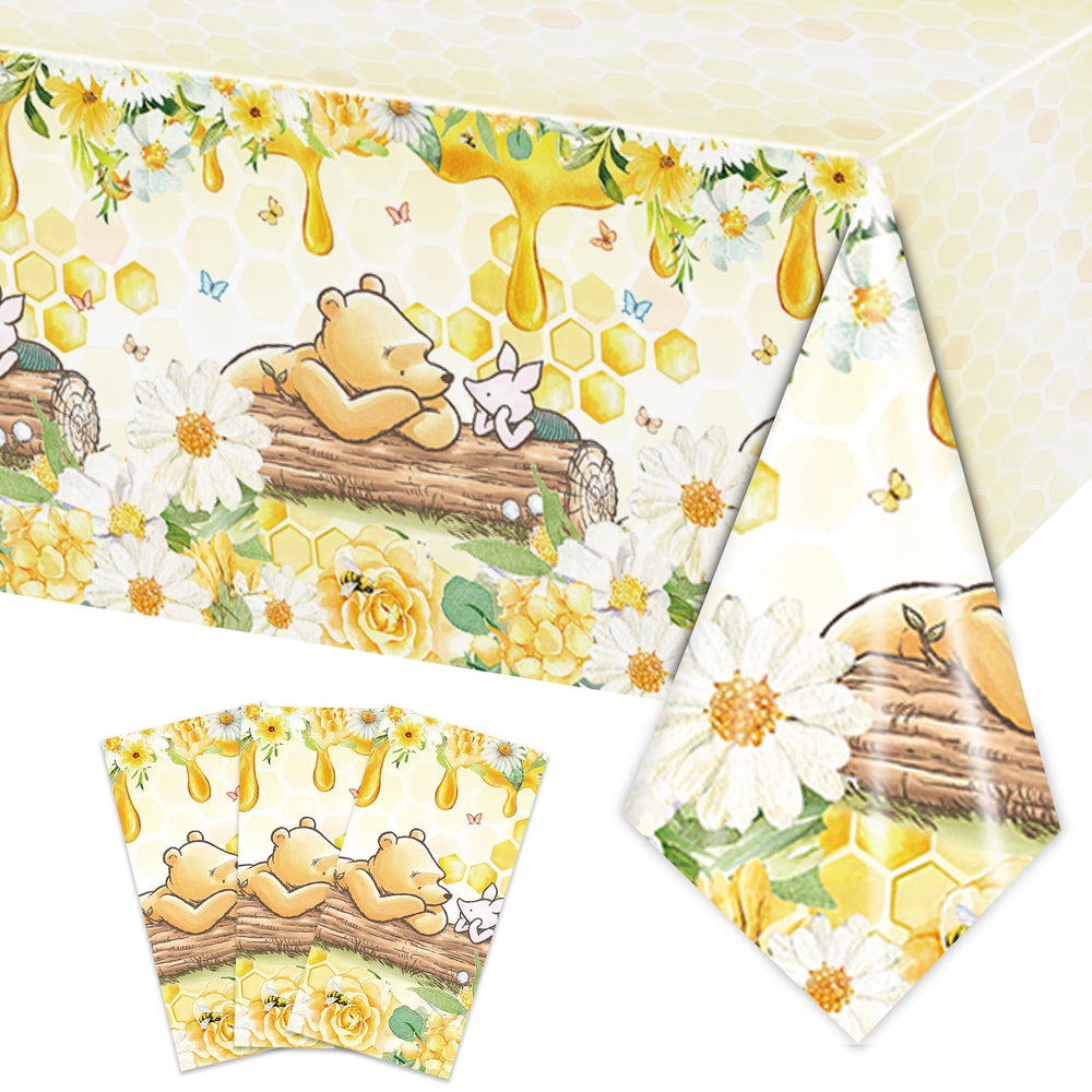 FOLNESH Winnie Bear tablecloth set on a rectangular table, protecting surfaces during a kid's party.