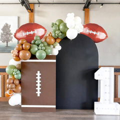 FunHot brown football print balloons emphasize the game theme at celebrations.