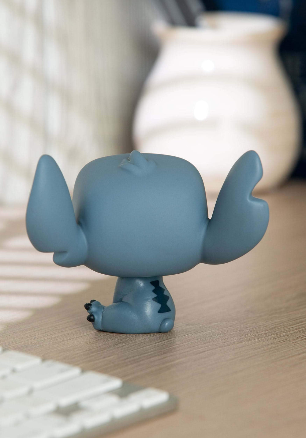 Funko Pop Disney Lilo & Stitch seated figure adds charm to a collectible display.
