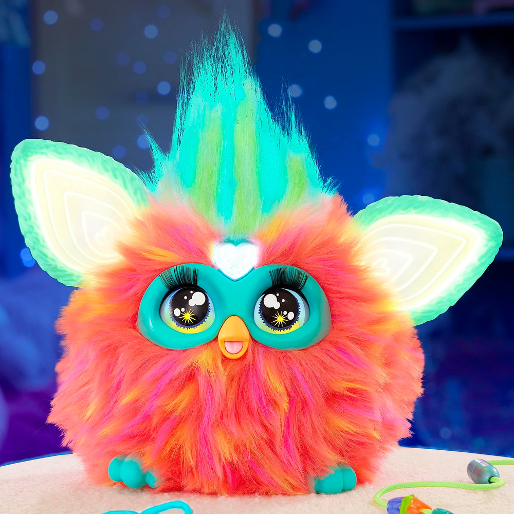 Furby Coral hair grooming with a comb for playful care.