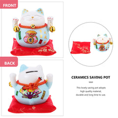 Garneck Lucky Cat Money Bank on a desk beside a notebook for easy access.