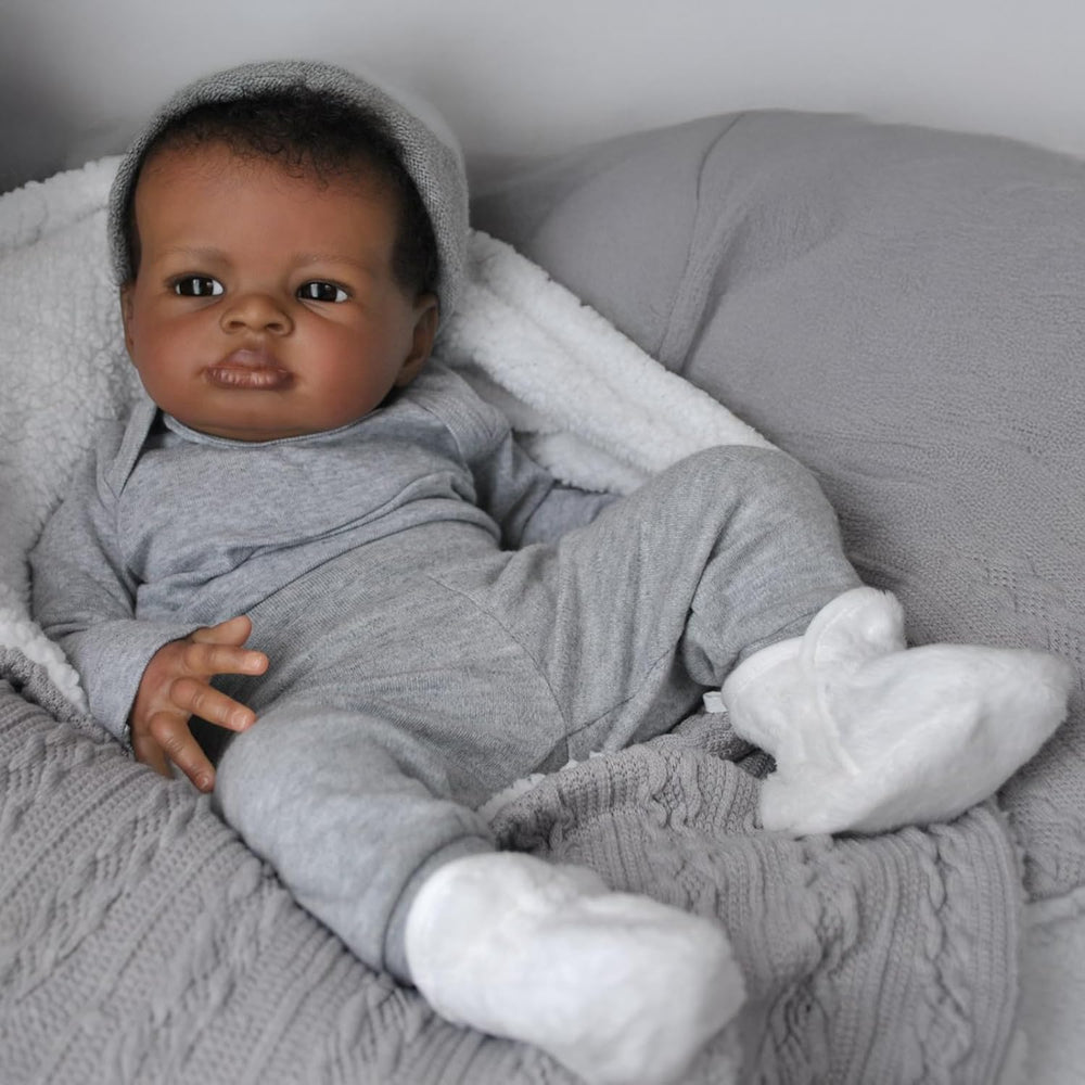 Generic realistic baby doll black boy face close-up showing lifelike eyes for imaginative play.
