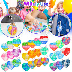 Genuvi pop heart keychain on desk demonstrates quiet fidgeting during class.