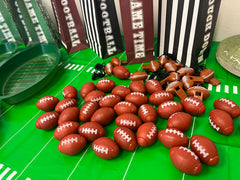 GiftExpress football-themed spinner showcased as party favors on a table.