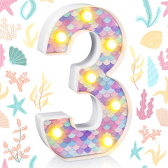 Glooglitter mermaid birthday light number 1 adds warm glow to centerpieces.