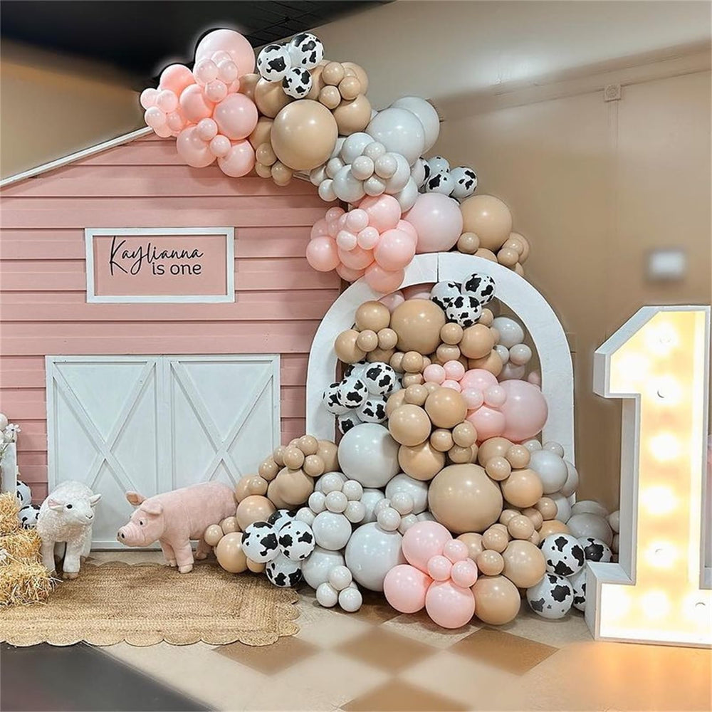 Govpy balloon arch ideas featuring cow print and pink tones