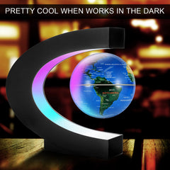 Gresus C-shaped LED frame surrounding the levitating globe for ambient desk lighting.