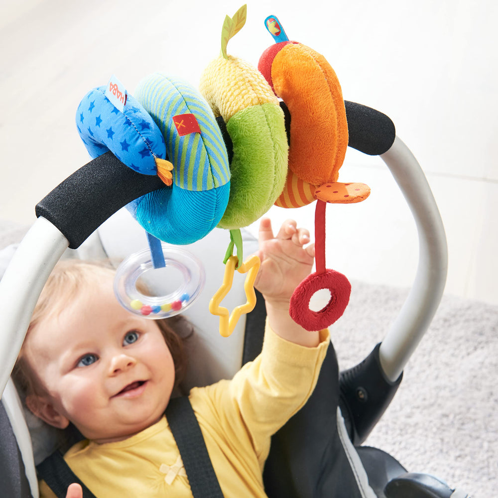 HABA Rainbow Activity Spiral teething-ring promotes soothing tactile exploration during trips