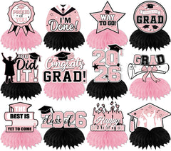 HAKOTI 12-pack pink graduation centerpieces with honeycomb design for class of 2026 tables.