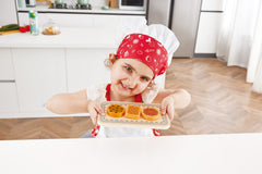 Hape child playing with the oven supports imagination and language growth.