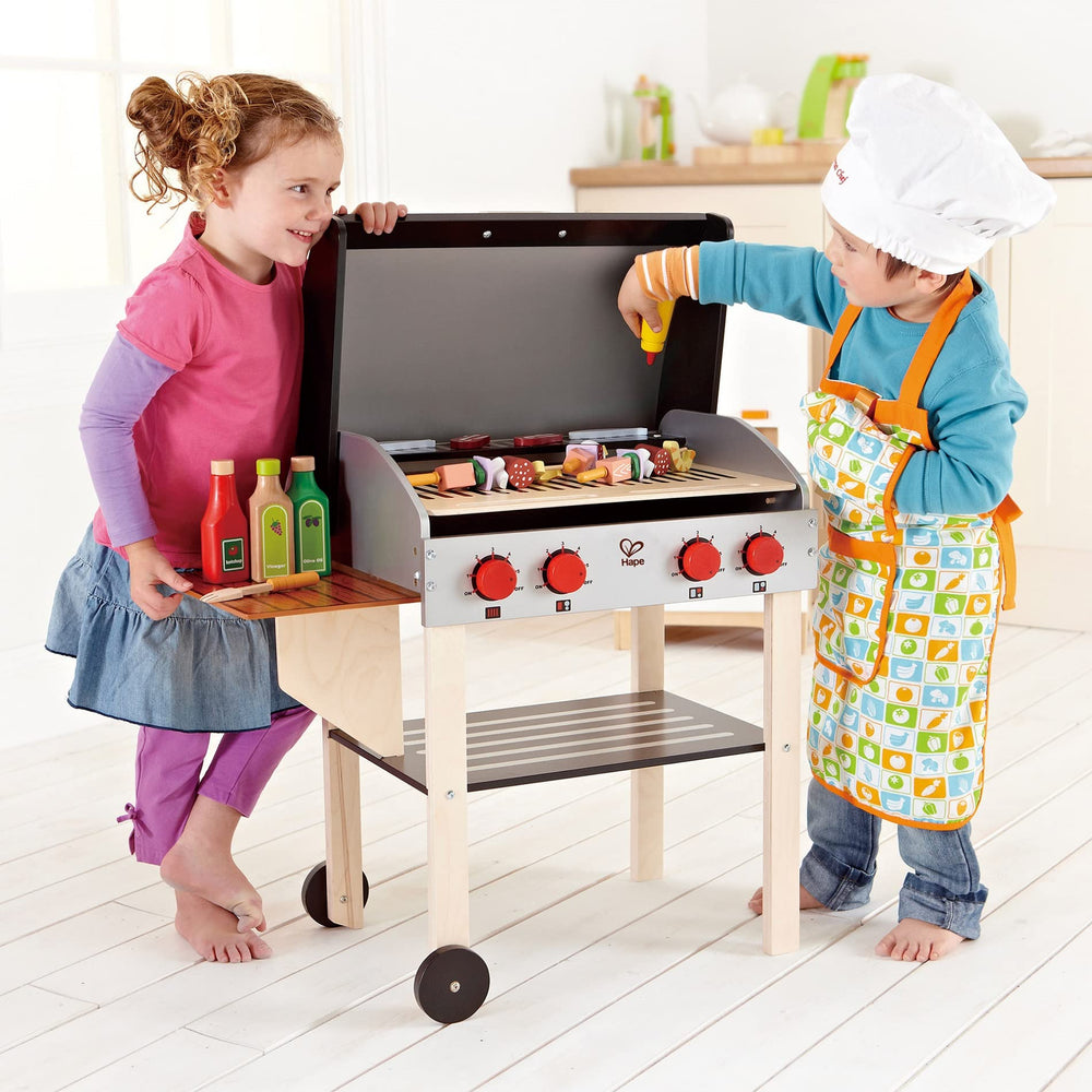 Hape Gourmet Grill glowing coals enhance immersive outdoor play.