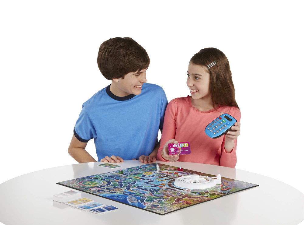Hasbro Gaming The Game of Life career-baby-house spaces illustrate life choices.