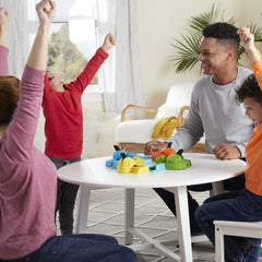 Hasbro Gaming Hungry Hungry Hippos action shot shows tail-pressing motion for rapid feeding.