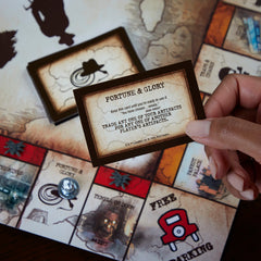 Hasbro Gaming Monopoly Indiana Jones Edition board-artwork evokes classic adventure scenes.
