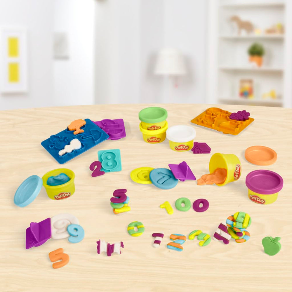 Counting activity with number stampers and molds to guide practice.