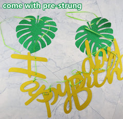 Hegbolke Hawaiian banner palm leaf decor enhances beachy party ambiance.