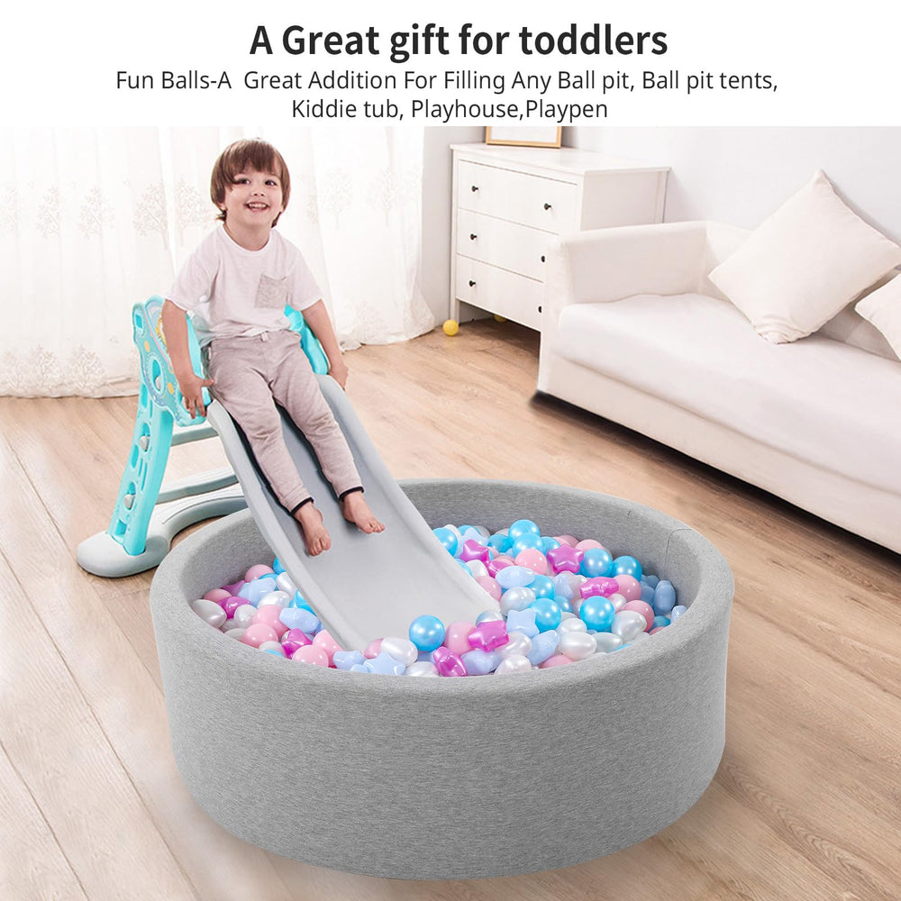 Heopeis toddler hands grasping balls supports fine motor skills practice.