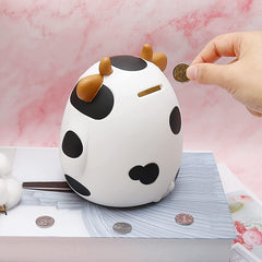 HW Cow Piggy Bank open slot; easy coin deposits for kids.
