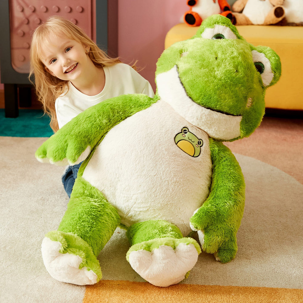 IKASA giant frog plush used as bedside decor in a child’s room.