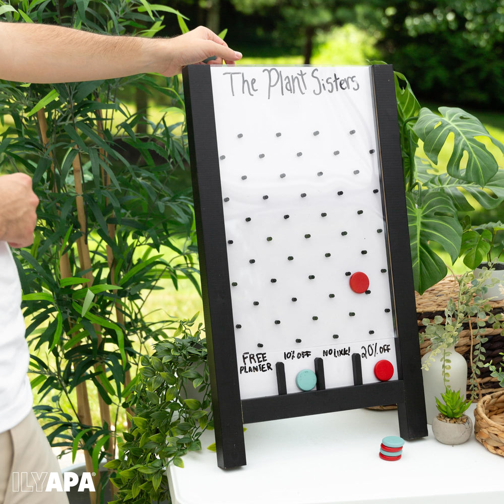 Booth setup shows attendee engagement with the Ilyapa prize drop activity.