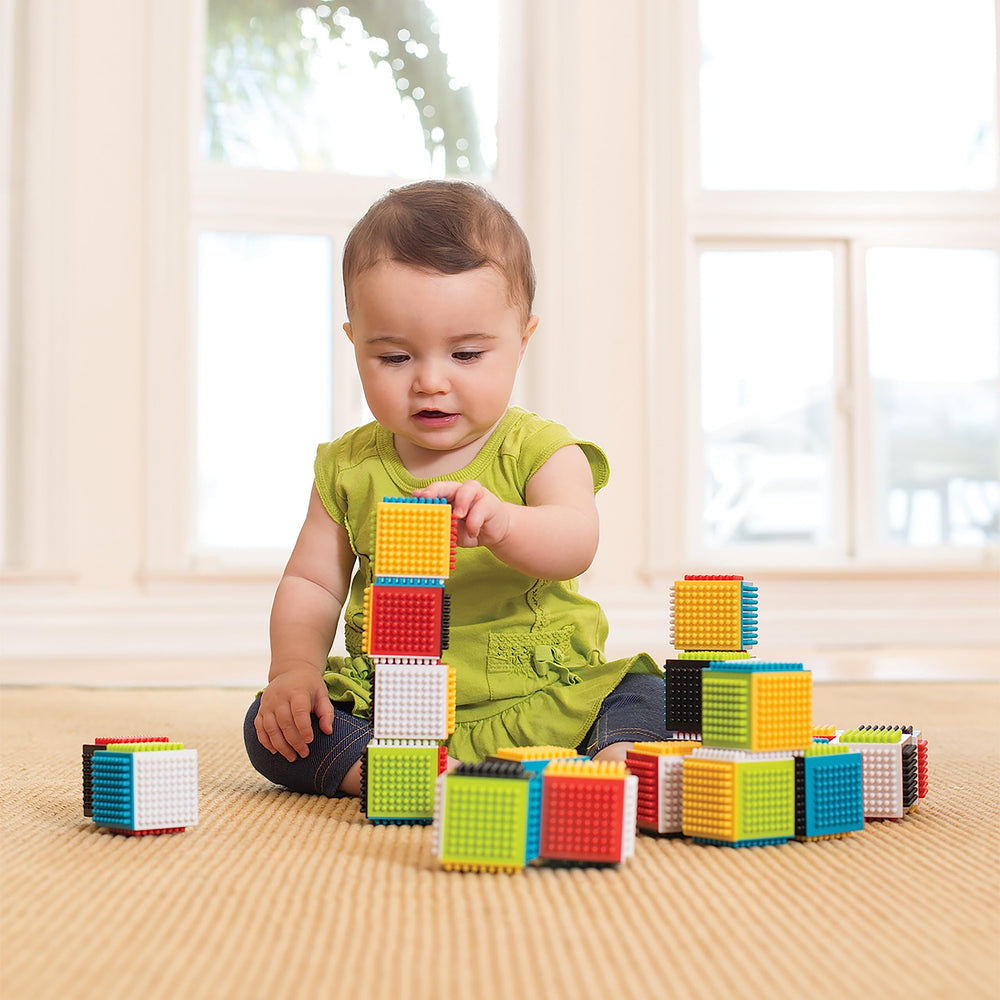Infantino Press & Stay blocks with interlocking pattern improving attachment and pull-apart play.