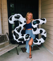 IWERP 40-inch cow print balloon coordinates with other farm party supplies.