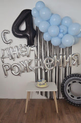 IWERP black 4th birthday balloon highlights the stage backdrop with elegant contrast.