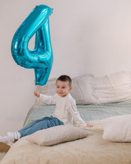 IWERP 4th birthday blue foil balloon adds dramatic height to decor.