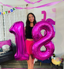 IWERP first-birthday setup with rosy purple balloon creating festive backdrop.