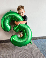 IWERP green number 5 birthday balloon display enhances vibrant backdrops.
