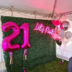 IWERP hot pink foil balloon backdrops offer a glamorous focal point.