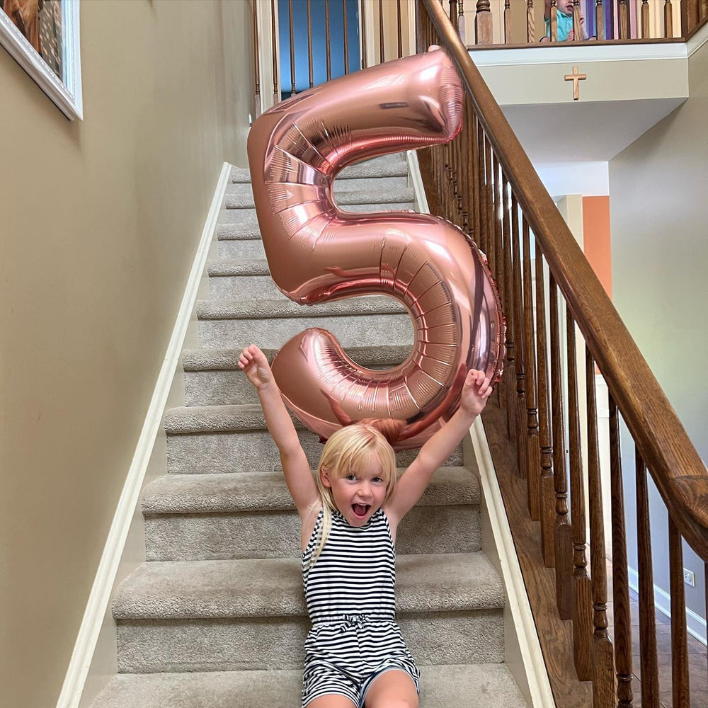 IWERP rose gold birthday balloon decor elevates party aesthetics with radiant foil shimmer.
