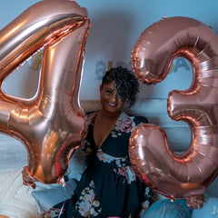IWERP Rose Gold Number 4 Balloon as stage backdrop for vibrant birthday photos.
